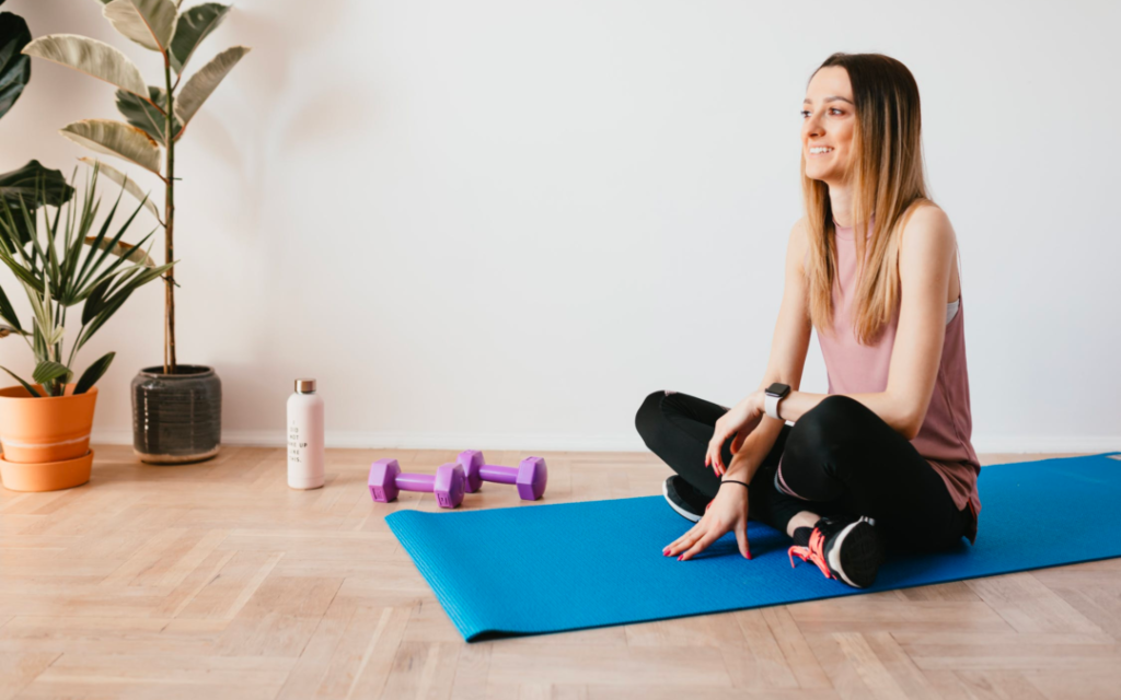 woman sitting on yoga mat